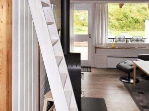 a staircase in a room with a table and chairs at 6 person holiday home in Aabenraa in Aabenraa