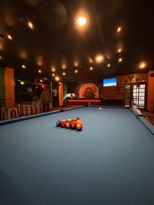a pool table with balls on top of it at Butter Hotel in Otari