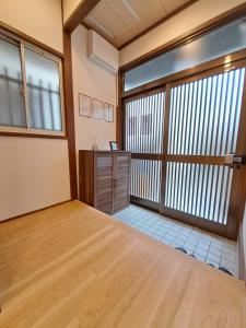 an empty room with a large window and a desk at Out of Office Hostel by 旅路 in Fukuoka +12 photos