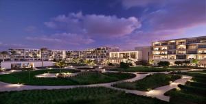 a view of a resort at night with buildings at Address Beach Resort Marassi in El Alamein +45 photos