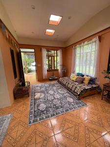 a bedroom with a bed and a large rug at Zen Mountain Escape 3BR Getaway near Chirripó in Rivas +15 photos