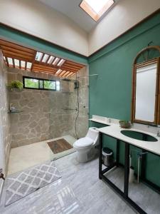 a bathroom with a shower and a toilet and a sink at Zen Mountain Escape 3BR Getaway near Chirripó in Rivas