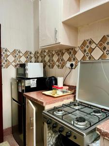 a kitchen with a stove and a counter top at Fibi Embu Apartments in Embu