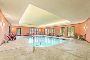 a pool in a hotel with chairs and tables at Comfort Suites Gothenburg South in Gothenburg