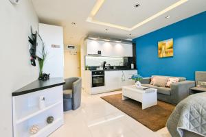 a living room with a couch and a table at N9 Studentski Loft in Sofia