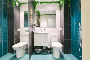 a bathroom with a toilet and a sink and a mirror at N9 Studentski Loft in Sofia +12 photos