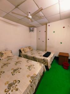 Postel nebo postele na pokoji v ubytování Hotel Priyashi International