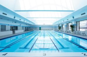 a large swimming pool in a building at Hotel Okura Kobe in Kobe
