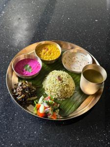 a plate of food with rice and vegetables on a table at Yara Wellness in Munggu +32 photos