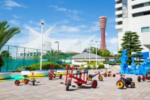 a group of childrens tricycles parked in front of a beach at Hotel Okura Kobe in Kobe