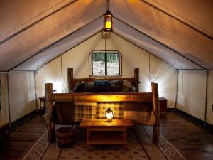 a room with a tent with a table in it at Rustic Safari Tent for a Unique Glamping Experience near Gore Mountain, New York in North Creek