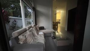 a living room with a couch and a glass table at Terres D'Angkor in Phumĭ Kruŏs +41 photos