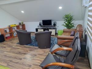 a living room with leather furniture and a tv at New Modern Duplex with Free Parking in Prijepolje