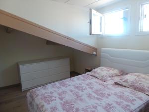 a bedroom with a bed and a stair case at Coeur de Sète - Heart of Sète in Sète