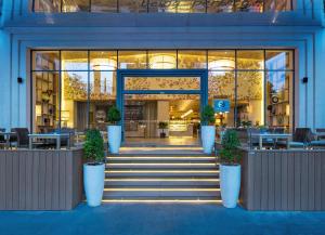 a building with potted plants in front of it at Fusion Suites Saigon in Ho Chi Minh City