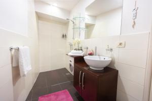 a white bathroom with a sink and a mirror at Gloria apartment Rovinj - Heart of Old town - Steps from Sea in Rovinj +26 photos