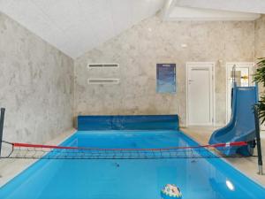 a swimming pool with a pool net in a room at 5 star holiday home in Dronningmølle in Dronningmølle