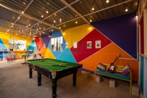 a room with a pool table and colorful walls at goSTOPS Bengaluru, Gandhi Nagar Majestic in Bengaluru