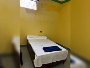 a bedroom with a bed in a yellow room at SPOT ON Dream Guest House in Kankather