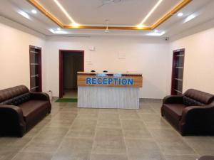 a reception room with a podium with a reception sign at SPOT ON Khushi Lodge in Kurua