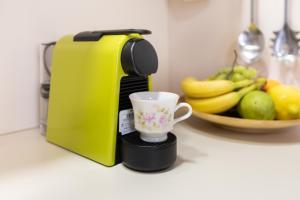 a yellow coffee maker and a cup on a counter at Gloria apartment Rovinj - Heart of Old town - Steps from Sea in Rovinj
