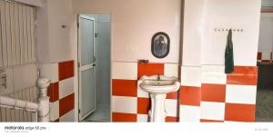 a bathroom with a sink and a toilet at SPOT ON Hotel Parvati Resort in Suitha +45 photos