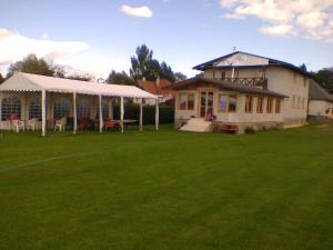 a house with a tent and a grass yard at Penzión Šindléry 533 in Partizánska ľupča