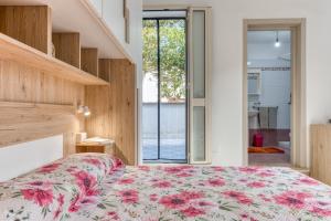 a bedroom with a bed with a floral bedspread at Mauricarol Residences in Acquarica del Capo