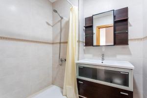 a bathroom with a sink and a mirror at Viviaro Llibertat in Puerto de Sagunto +14 photos