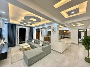 a living room with a couch and a kitchen at Zuri Cosy Stay Nyali, Furnished 2 bedroom in Mombasa