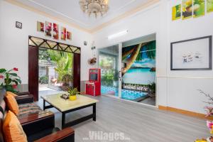 a living room with a couch and a table at Villa Bãi Sau Vũng Tàu Free SUB - Xe Máy in Vung Tau +44 photos