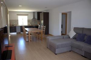 a living room with a couch and a table at Casa do Regueirinho in Vila Nova de Cerveira