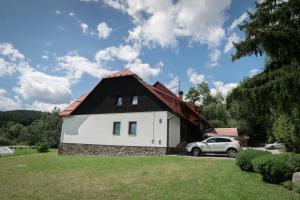 a house with a car parked in front of it at Penzion Ekosport in Stachy