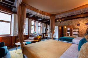a bedroom with a large bed and a living room at Charming Suites Jan Zonder Vrees in Antwerp