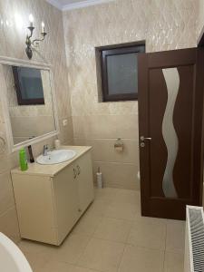 a bathroom with a sink and a mirror at Magical Desire in Bragadiru