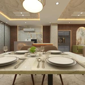 uma sala de jantar com uma mesa com pratos e talheres em Hotel Vista Haven em Patna