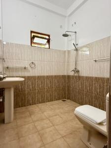 a bathroom with a shower and a toilet and a sink at il Mio Mirissa in Mirissa +50 photos