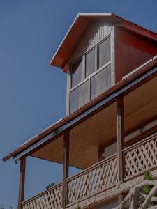 a large wooden house with a balcony at MaRu House in Dilijan