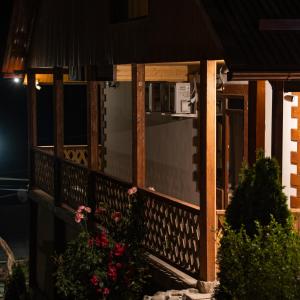 a porch of a house at night with flowers at MaRu House in Dilijan