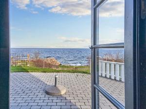 a view of the ocean from an open window at 5 person holiday home on a holiday park in Gudhjem in Gudhjem