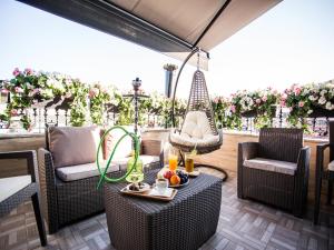 a patio with wicker chairs and a table with fruit on it at Bonne Sante Hotel in Istanbul