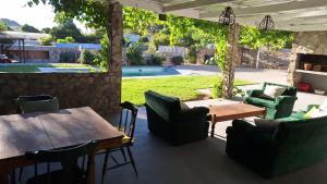 a restaurant with a table and chairs and a patio at Karoo Sunset Villa in Richmond