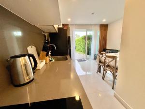 a kitchen with a tea kettle on a counter at Cozy Garden Apartment Butterfly Karon beach in Ban Karon