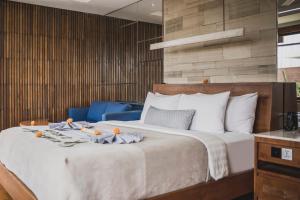 a bedroom with a large bed with towels on it at Sana Vie Villa Seminyak by Ini Vie Hospitality in Seminyak