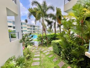 a view of the pool from the balcony of a building at Cozy Garden Apartment Butterfly Karon beach in Ban Karon