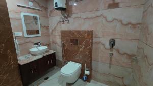 a bathroom with a toilet and a sink at Serene Vista Dharamshala in Dharmsāla +81 photos