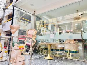 a store window with chairs and a table in it at ABCYQ Hotel in Bangkok +20 photos