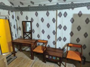 une pièce avec deux tables et deux chaises et un miroir dans l'établissement Desert Surprise Resort, à Jaisalmer