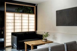 a living room with a couch and a table at Silent NOISELESS Homestay in Lijiang