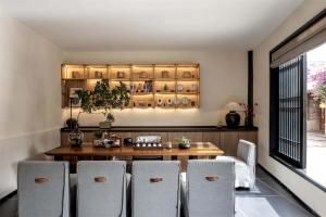 a dining room with a table and chairs at Silent NOISELESS Homestay in Lijiang